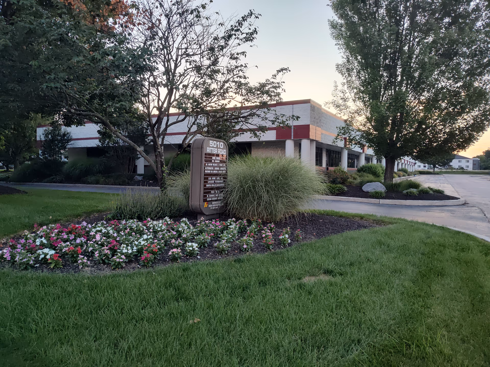 Exterior view of Cad Home Care, LLC building with landscaping and a sign.