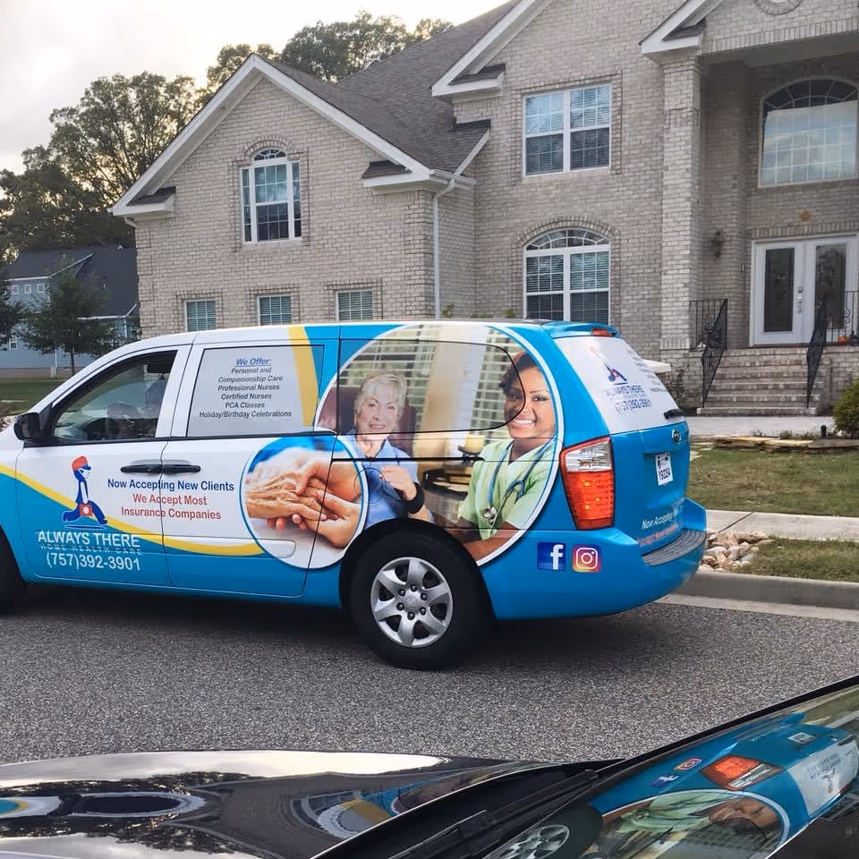 Exterior view of a brick senior living facility with a colorful branded health care van.
