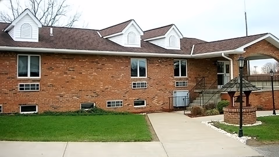 Front exterior view of Ridgeview Residential Care building with brick facade and lawn.