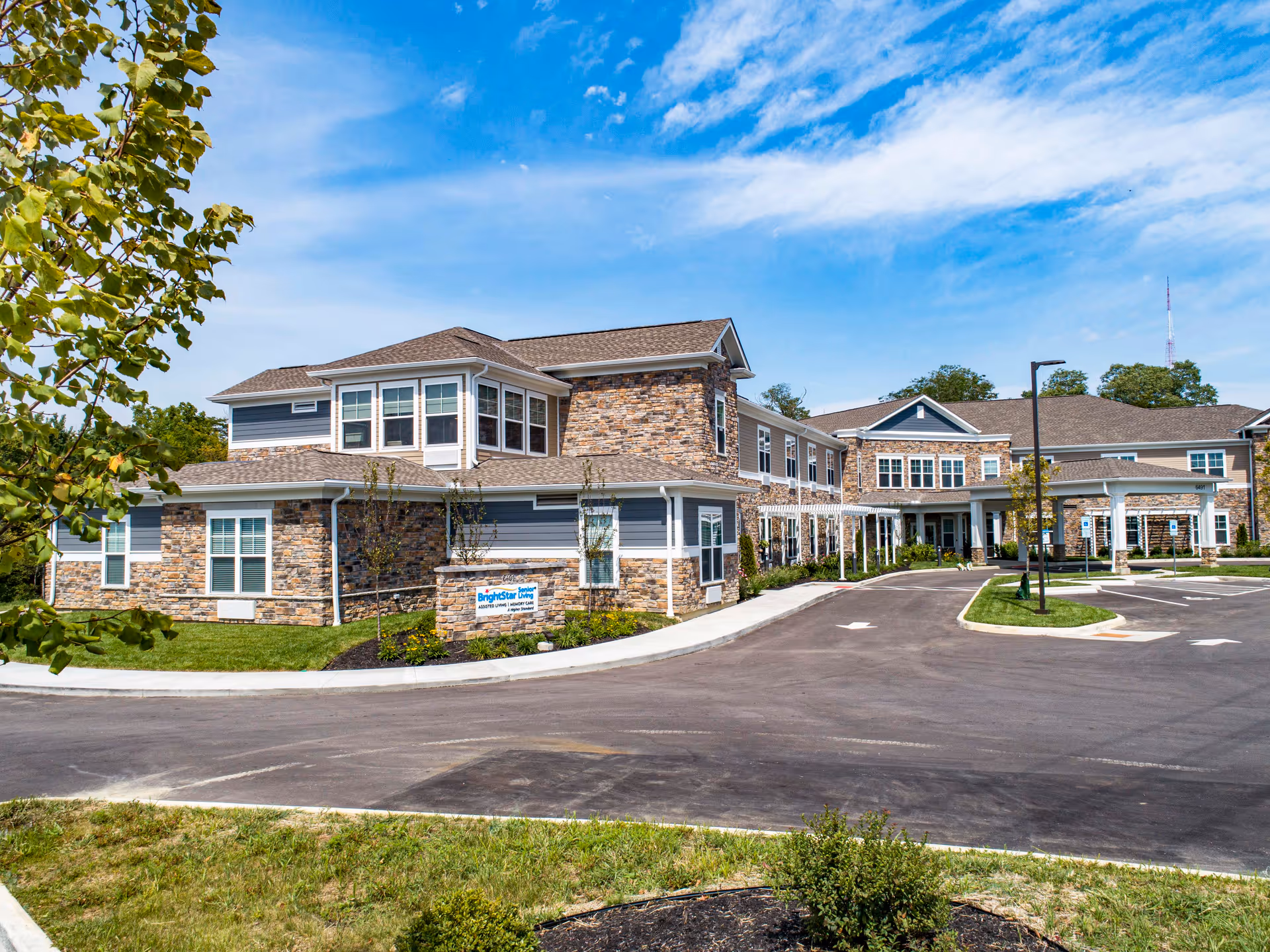 Exterior view of Brightstar Senior Living of Mason with stone accents and a circular driveway.