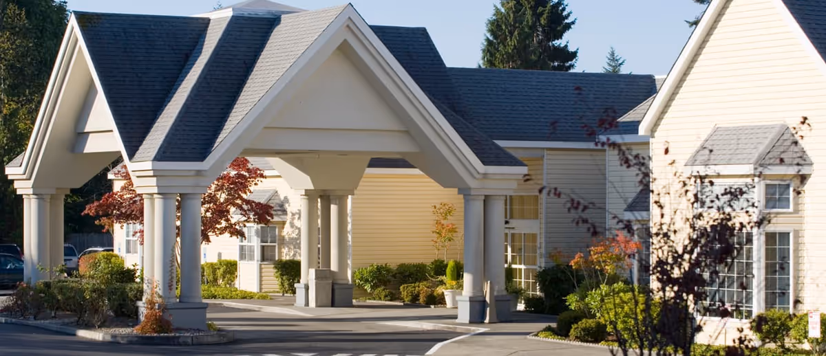 Wide view of Richmond Beach Rehab building exterior with a covered entrance and columns.