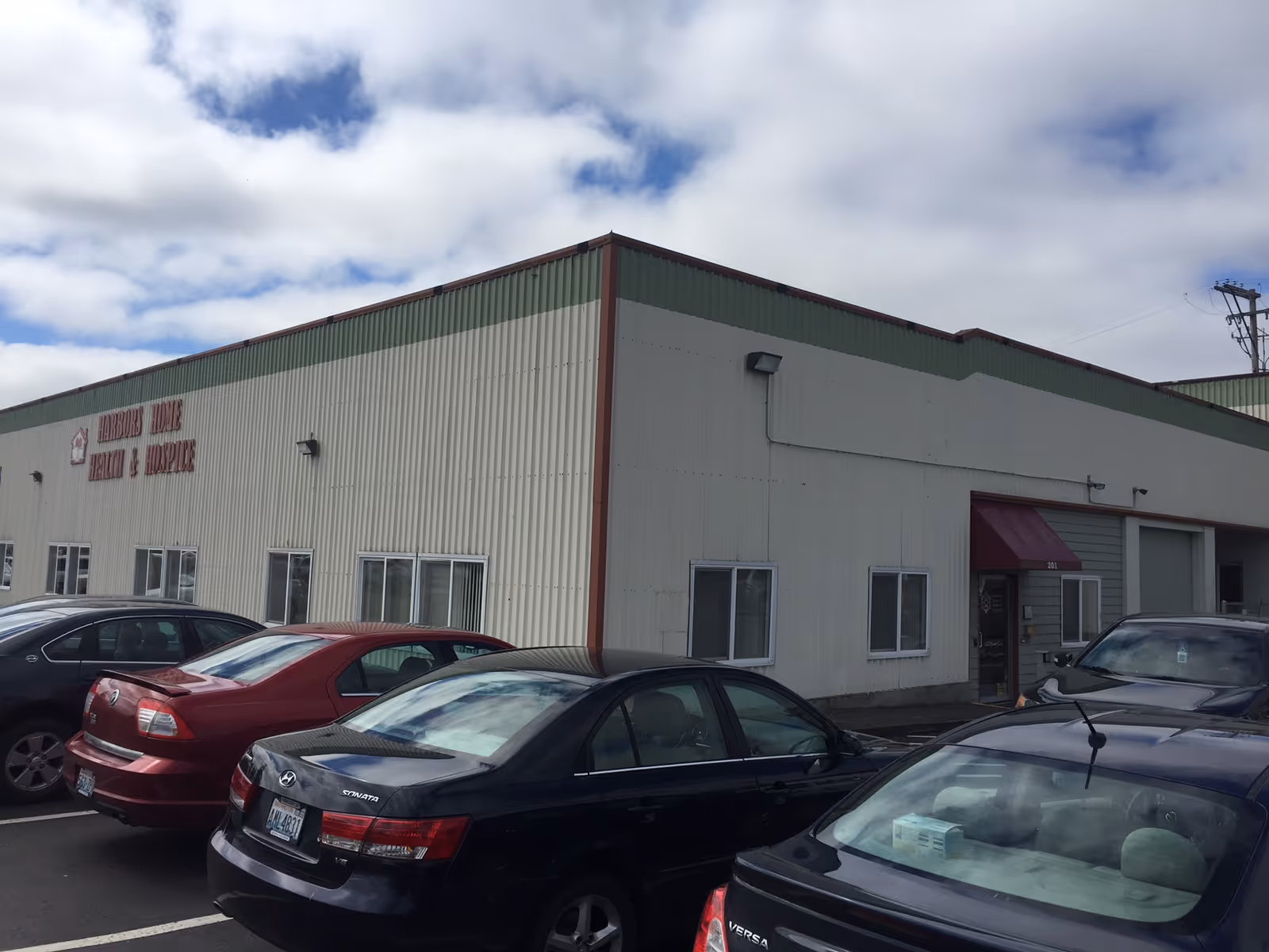 Exterior view of Harbors Home Health & Hospice building with a parking lot.