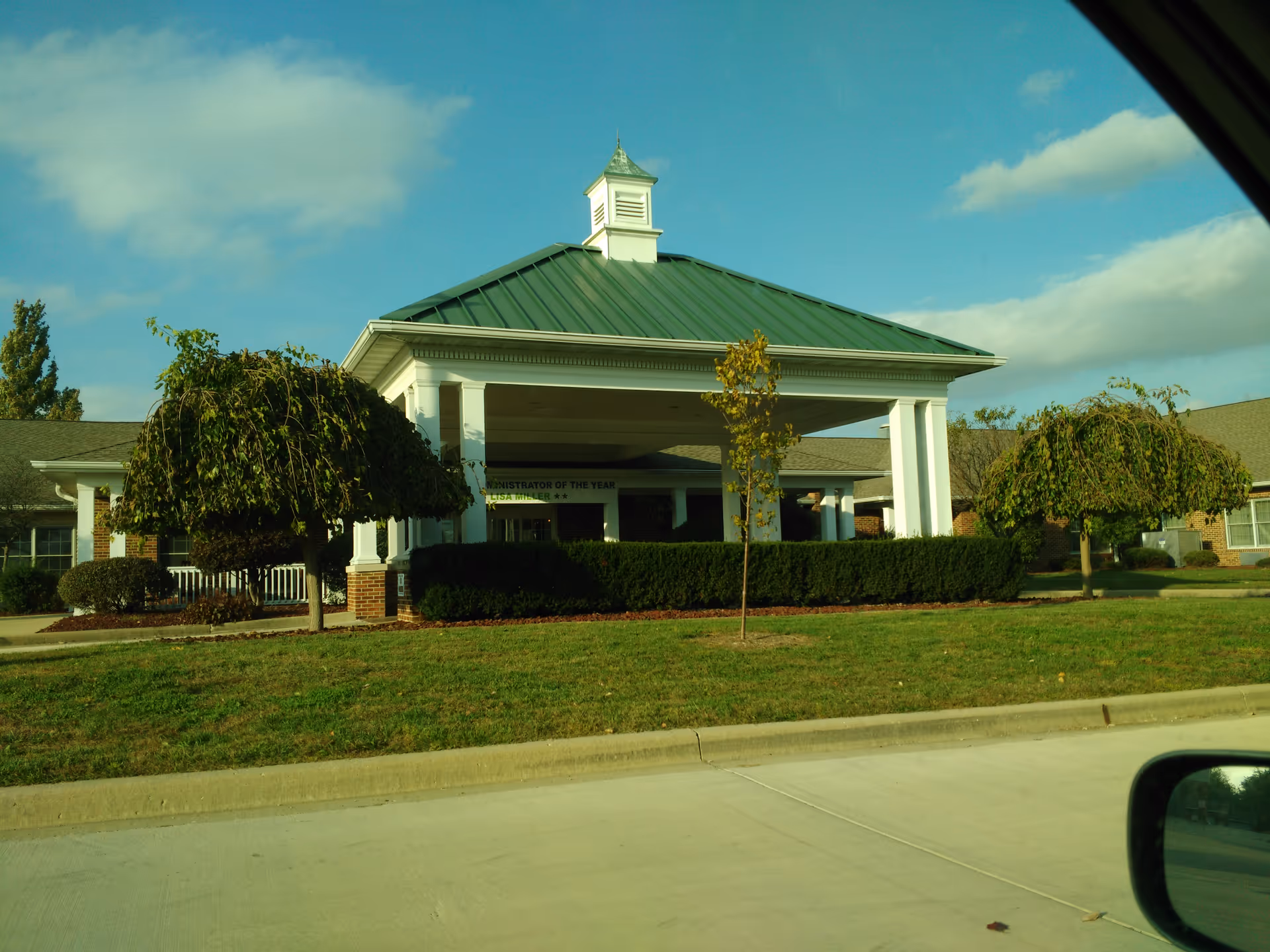 Front view of Hawthorne Inn entrance with a portico and manicured landscaping.
