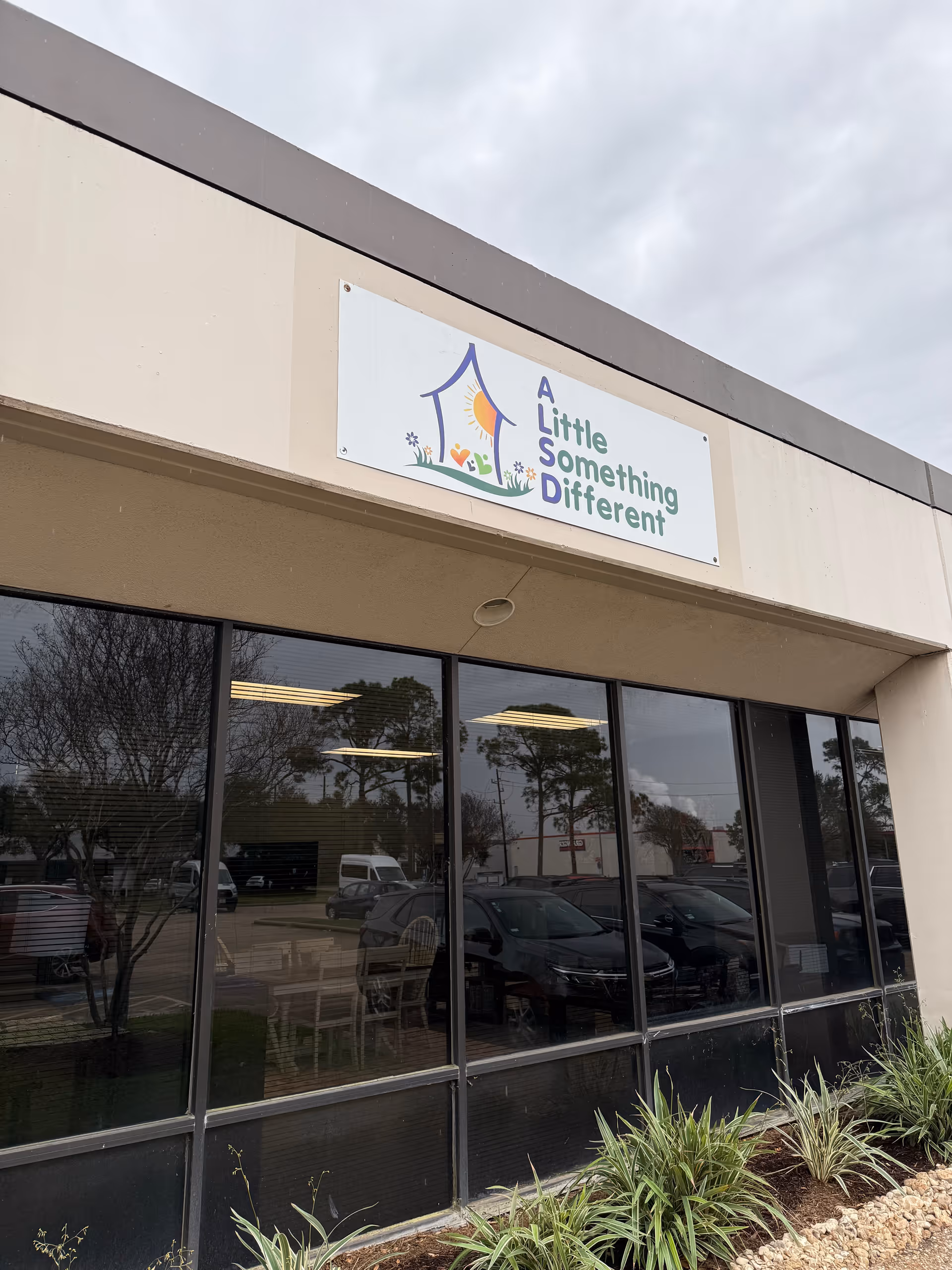 Exterior view of a building with a sign reading A Little Something Different.