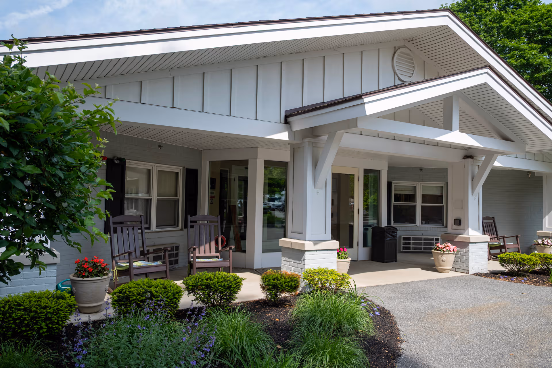 Front entrance of Seasons of Danvers with a covered porch and seating