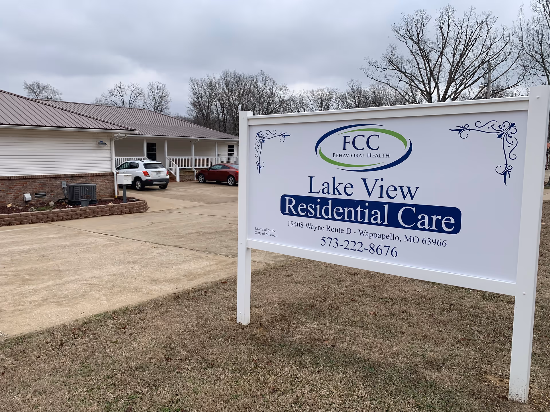 Exterior view of Lake View Residential Care sign with building and parking lot.