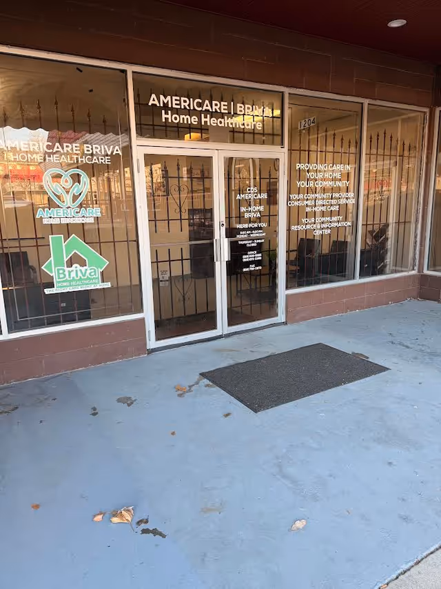 Storefront entrance with Americare Home Healthcare signage and glass doors.