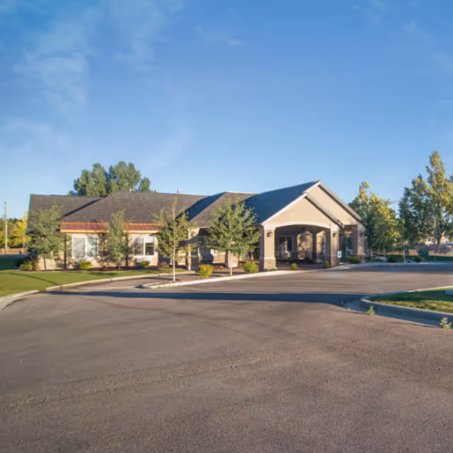 Exterior view of The Gables Assisted Living of North Logan building with entrance and parking.