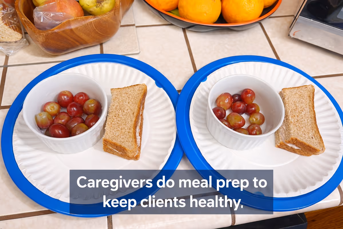 Two blue-rimmed plates with bowls of grapes and toast on a tiled kitchen counter.