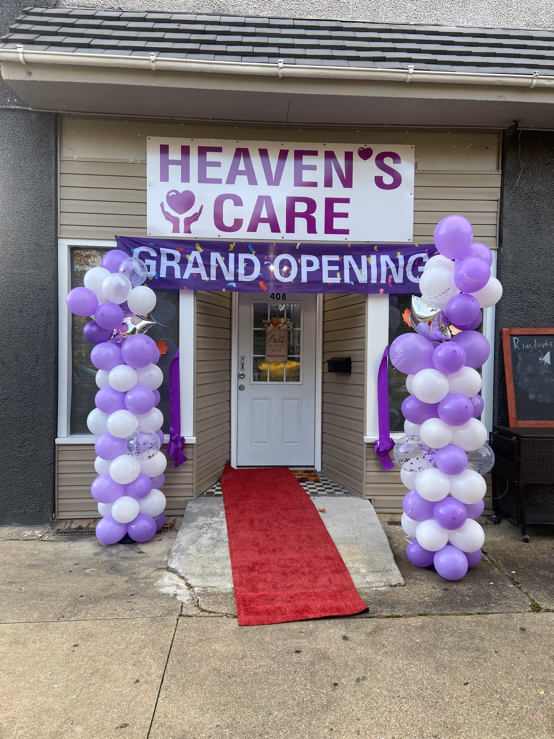 Entrance to Heaven's Care with purple balloon arches and red carpet.
