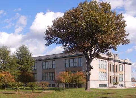 Exterior of RAH Winthrop Manor building surrounded by greenery and trees.