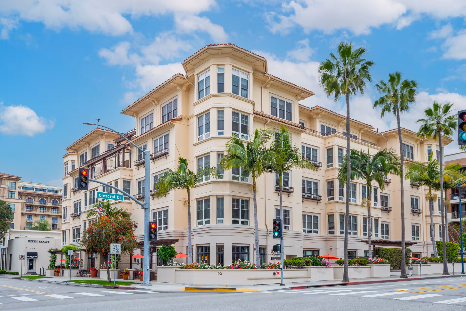 Sunrise of Beverly Hills exterior, multi-story senior living building with palm trees along a street