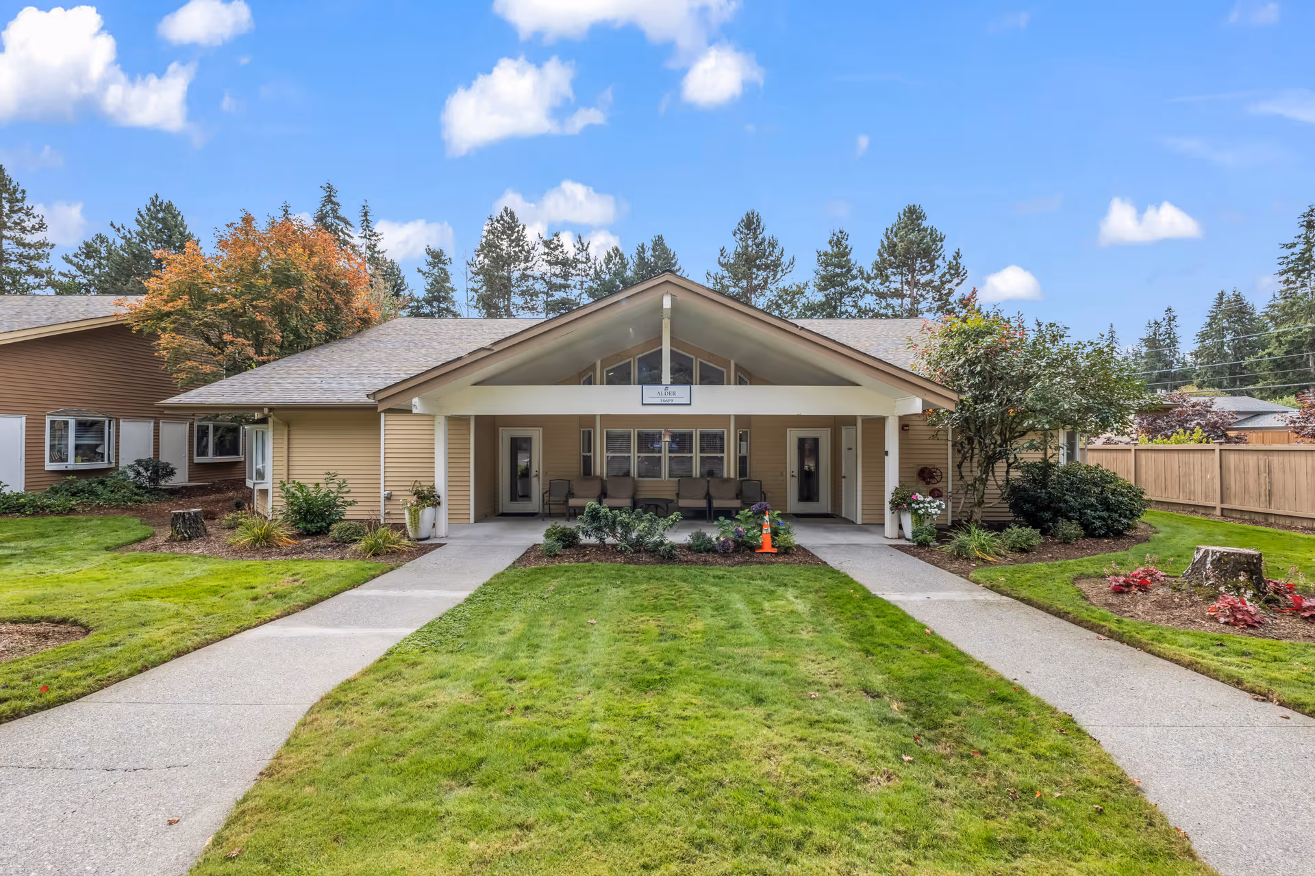 Single-story facility with a covered entrance, manicured lawn, and concrete walkways.