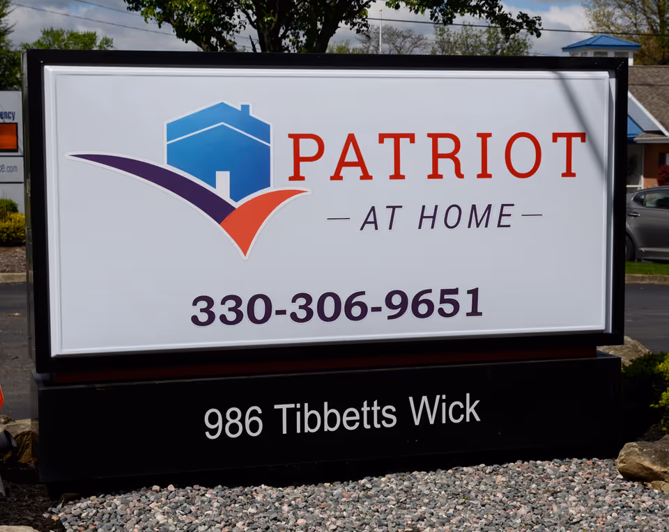 Outdoor Patriot at Home sign with phone number displayed at the facility entrance.