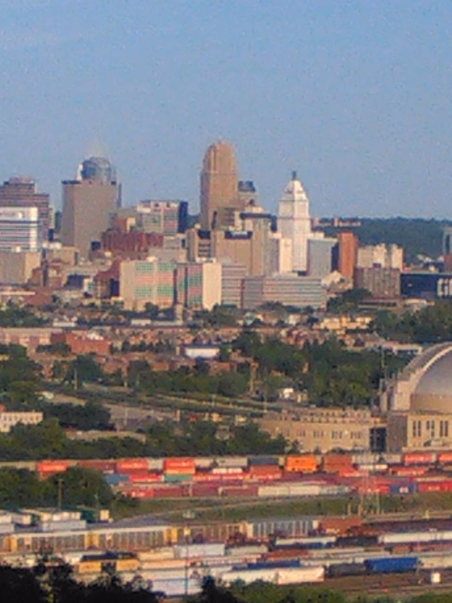 City skyline with tall buildings and a domed white structure.