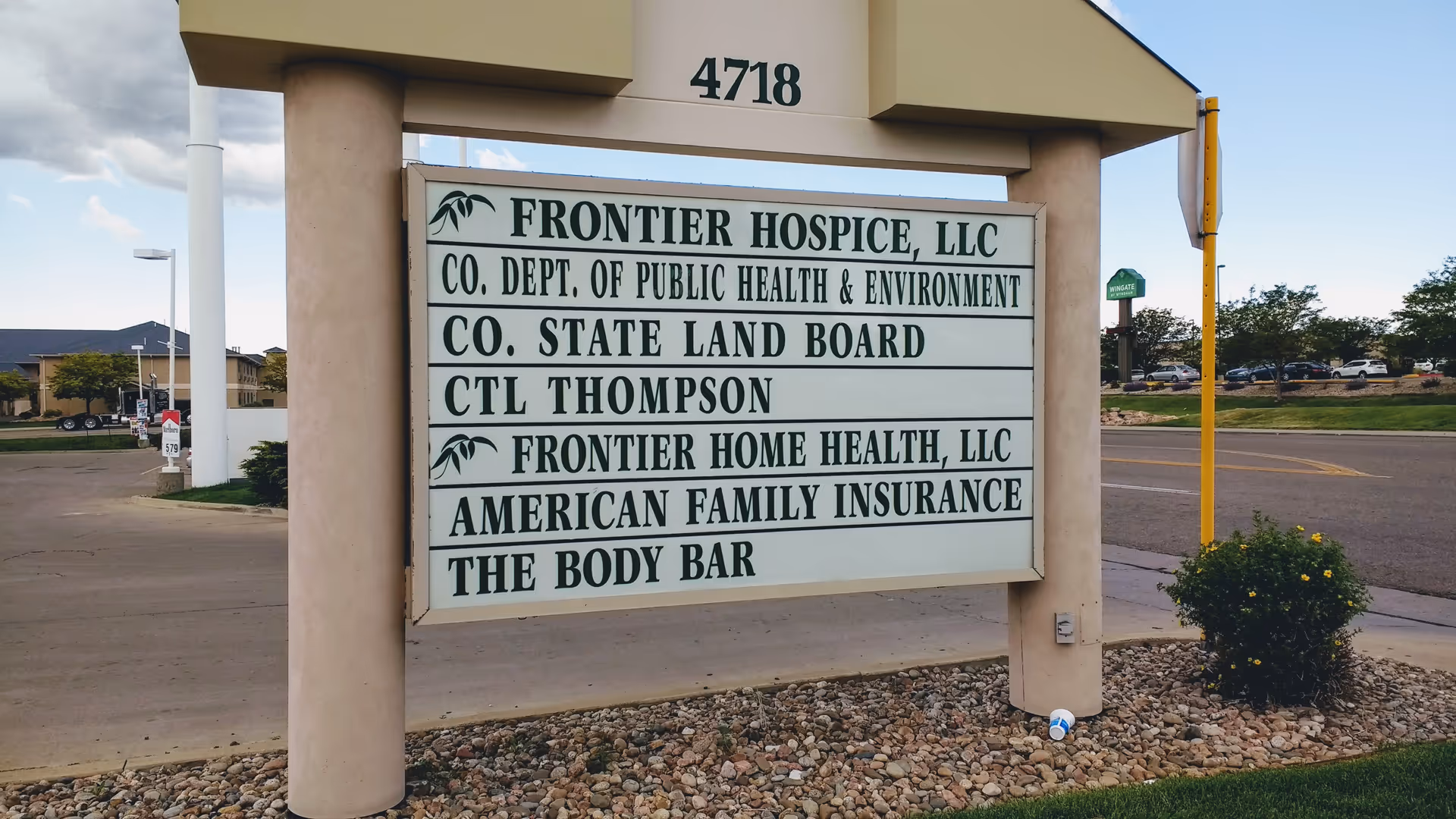 Exterior signboard shows Frontier Hospice and related organizations at a facility entrance.