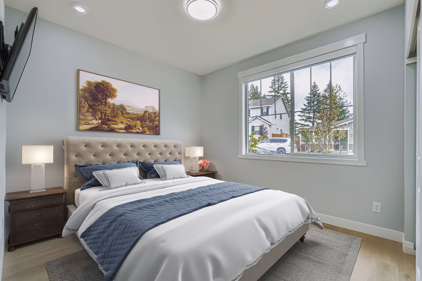 Light blue bedroom with tufted headboard bed, two nightstands, and a large street-facing window.