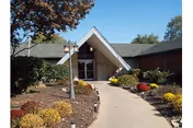 Front entrance of Westridge Health Care Center with a walkway and landscaped garden.
