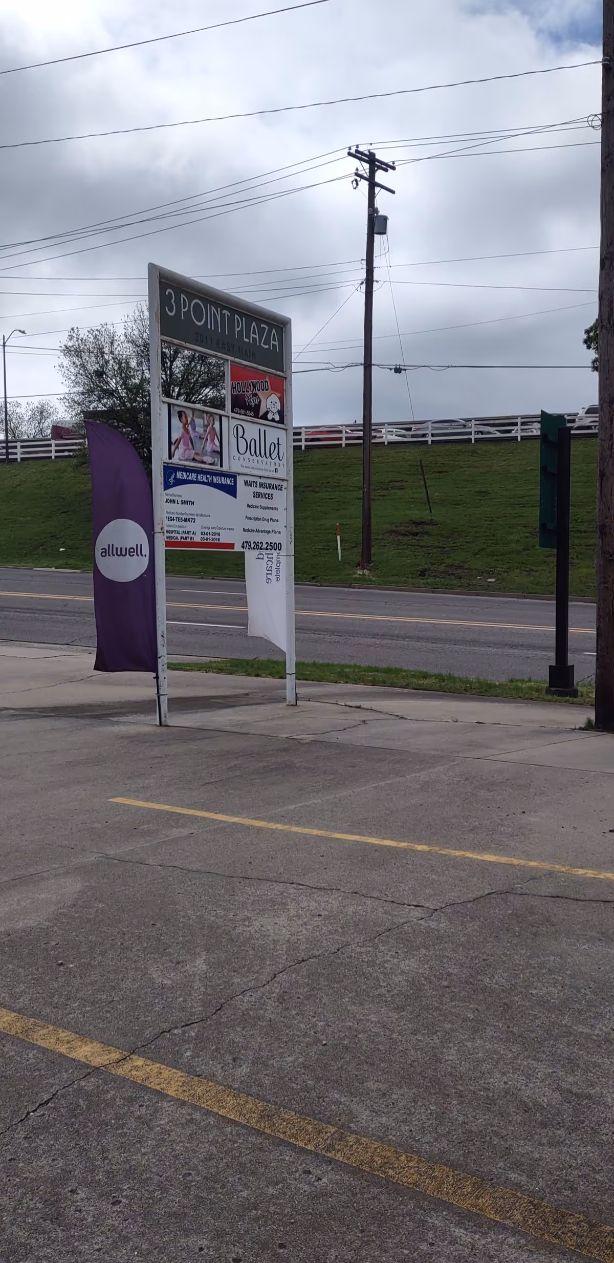 Outdoor street scene featuring a 3 Point Plaza sign and banners.