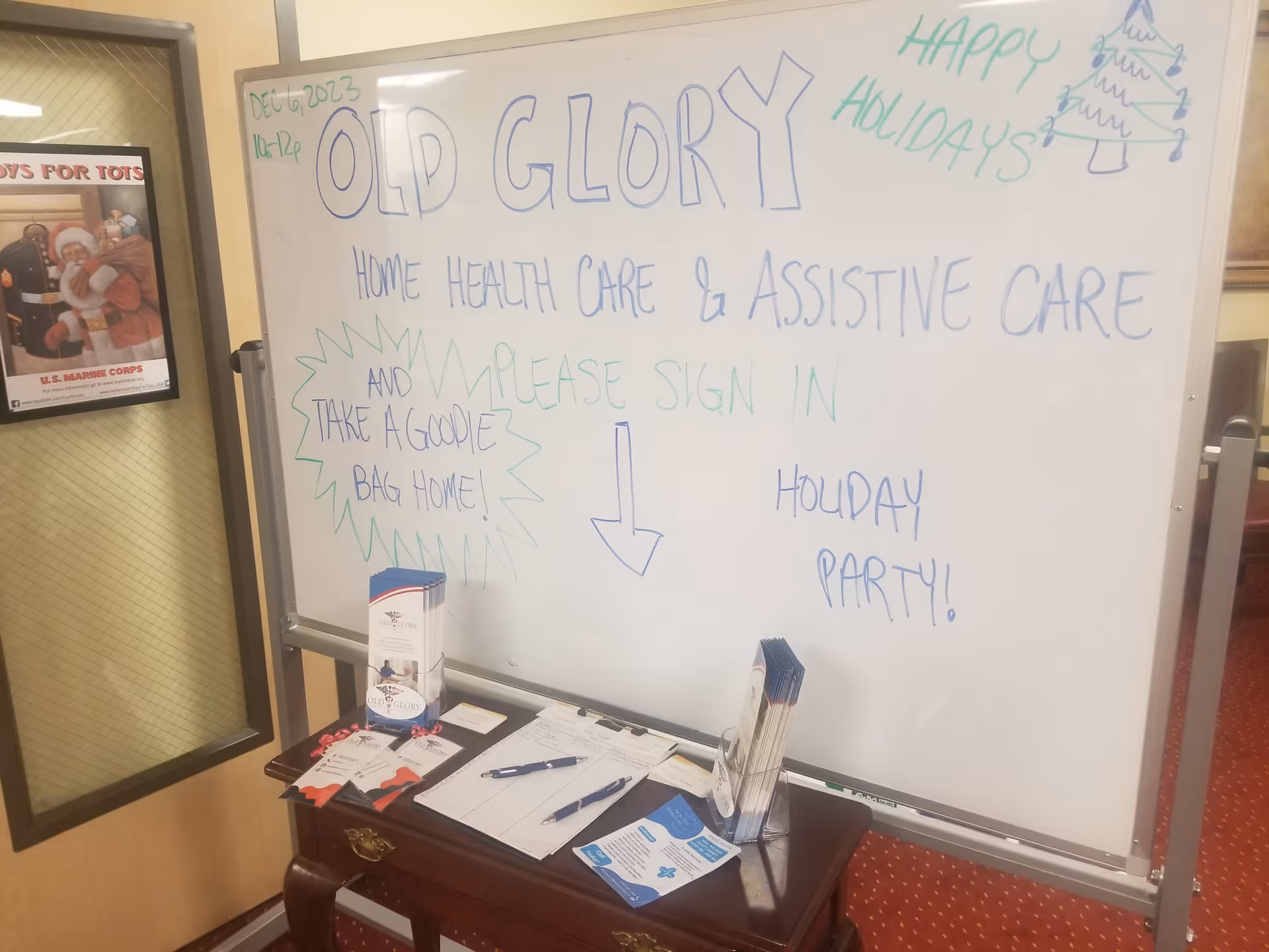Interior space featuring a whiteboard labeled Old Glory and a small desk with brochures.