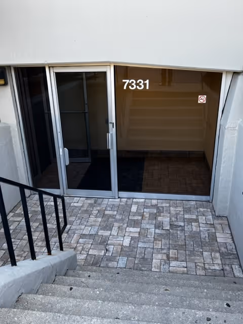 Entrance to Prime Senior Home Care with glass doors, numbered 7331, and tiled steps.