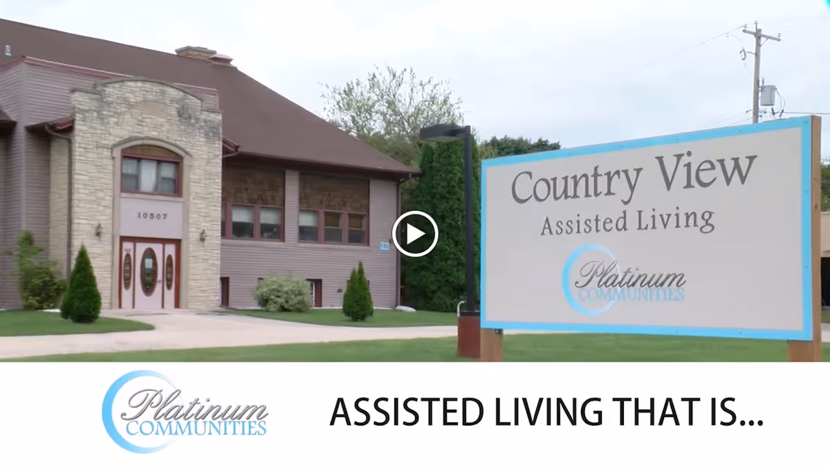 Exterior view of the Country View Assisted Living building with a large roadside sign and Platinum Communities logo.