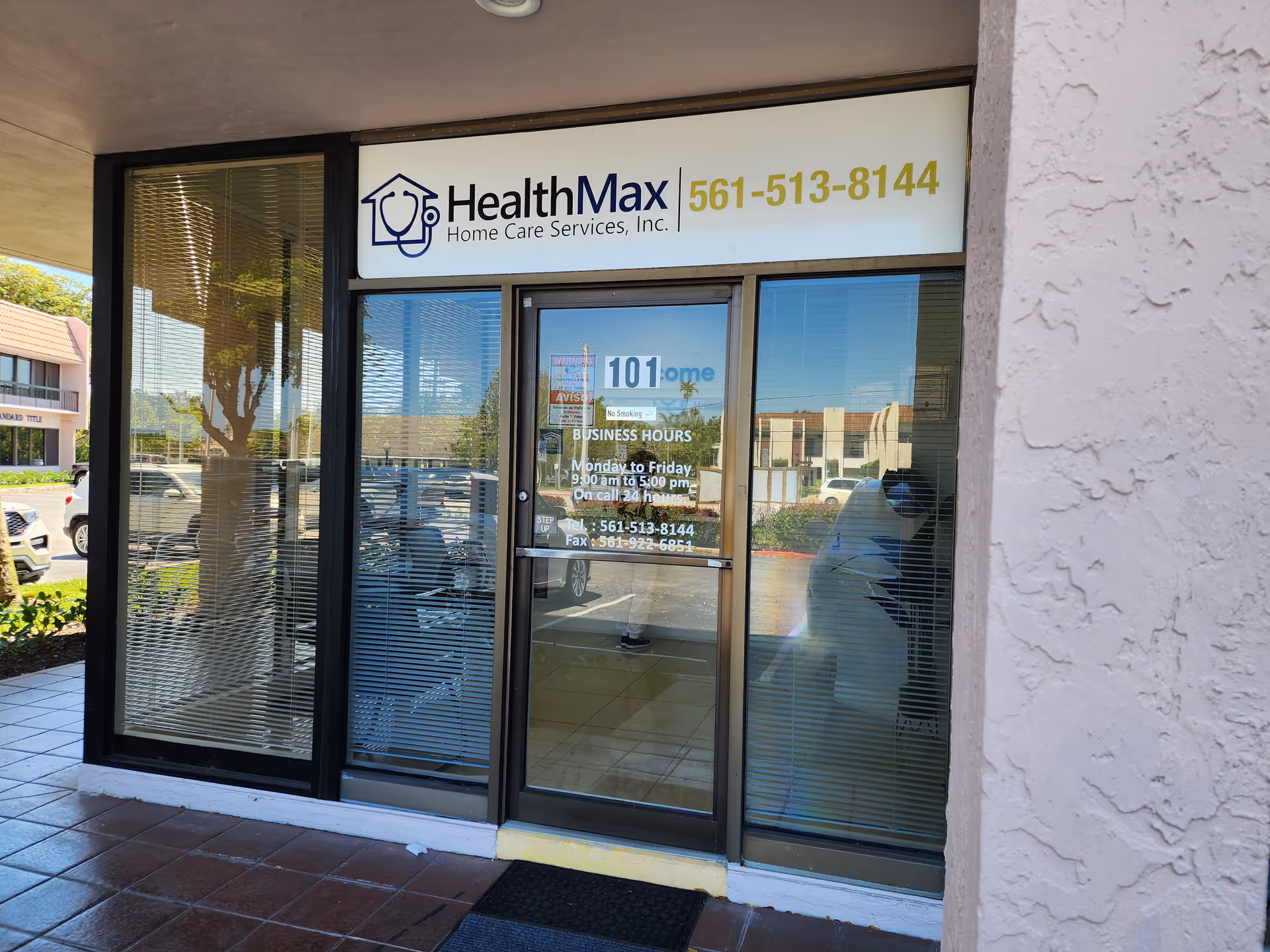 Exterior of HealthMax Home Care Services storefront with glass doors and signage.