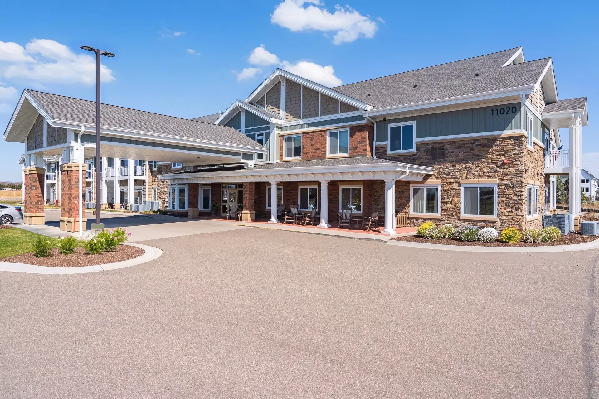 Exterior view of The Fields by New Perspective facility with driveway and entrance canopies.