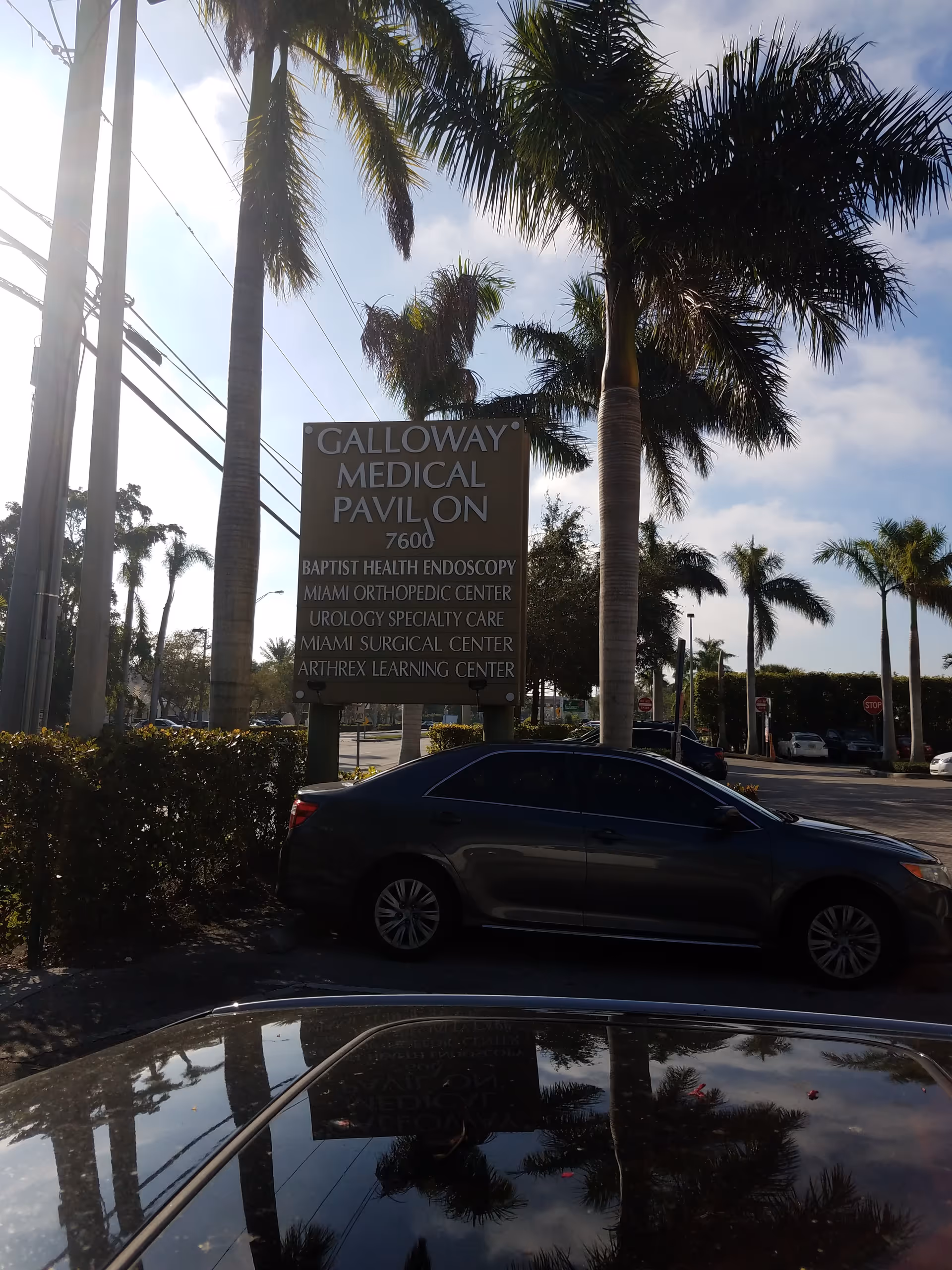 Sign for Galloway Medical Pavilion with palm trees and parked cars nearby.