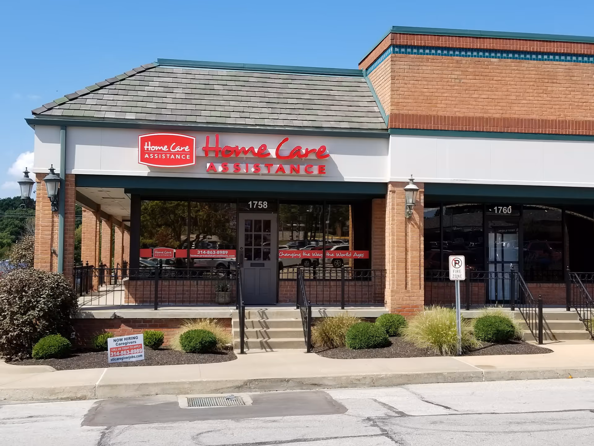Exterior view of a storefront with Home Care Assistance sign and brick facade.