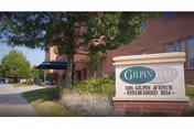 Exterior view of Gilpin Hall with entrance sign and pathway