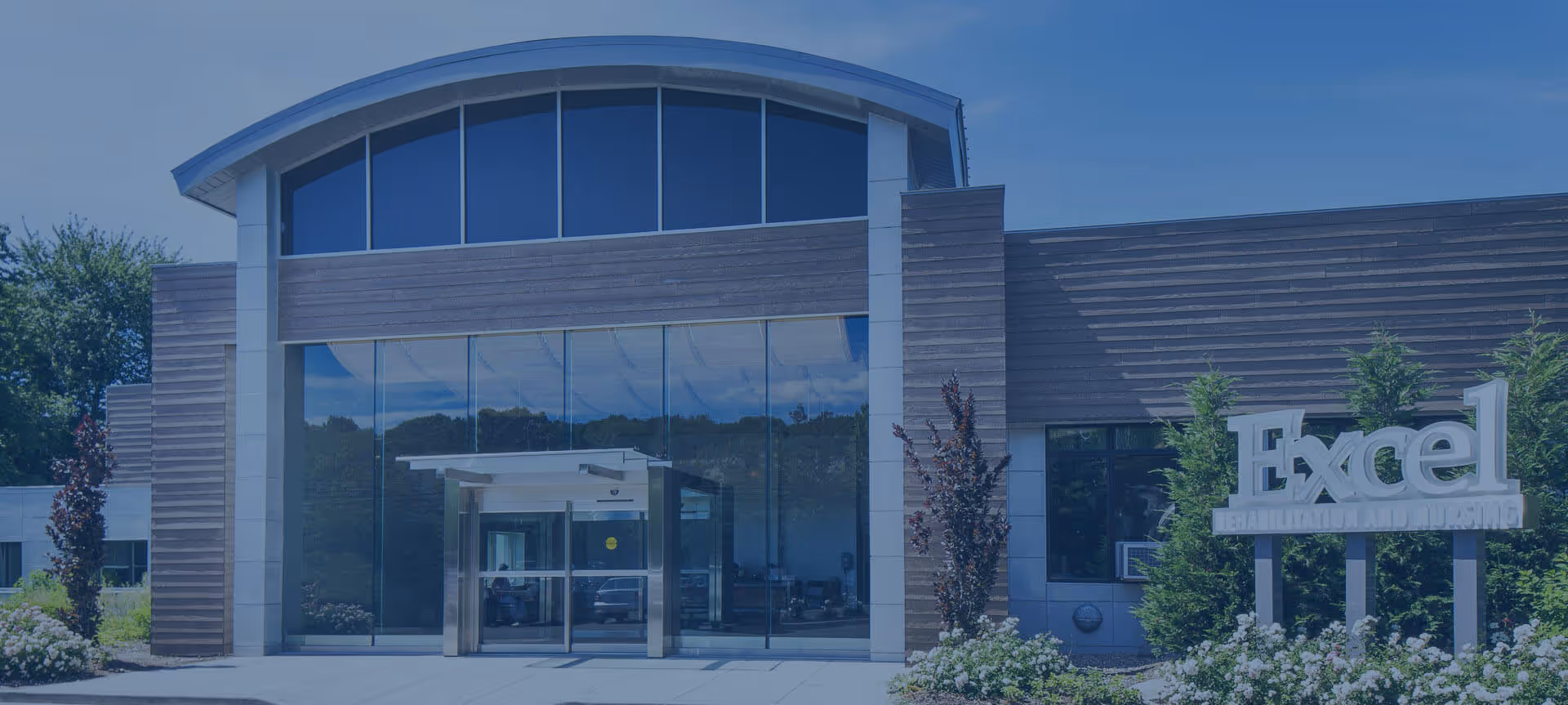 Front view of Excel at Woodbury for Rehab and Nursing with glass entrance doors.