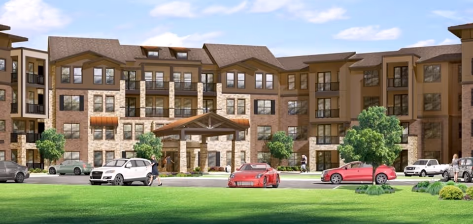 Exterior view of White Oak Manor Newberry with entrance canopy, cars, and green landscaping.