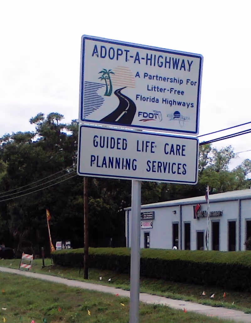 Outdoor sign for Guided Life Care Planning Services beside a building.