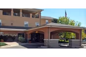 Front view of Libby Bortz Assisted Living entrance with a covered driveway and brick building