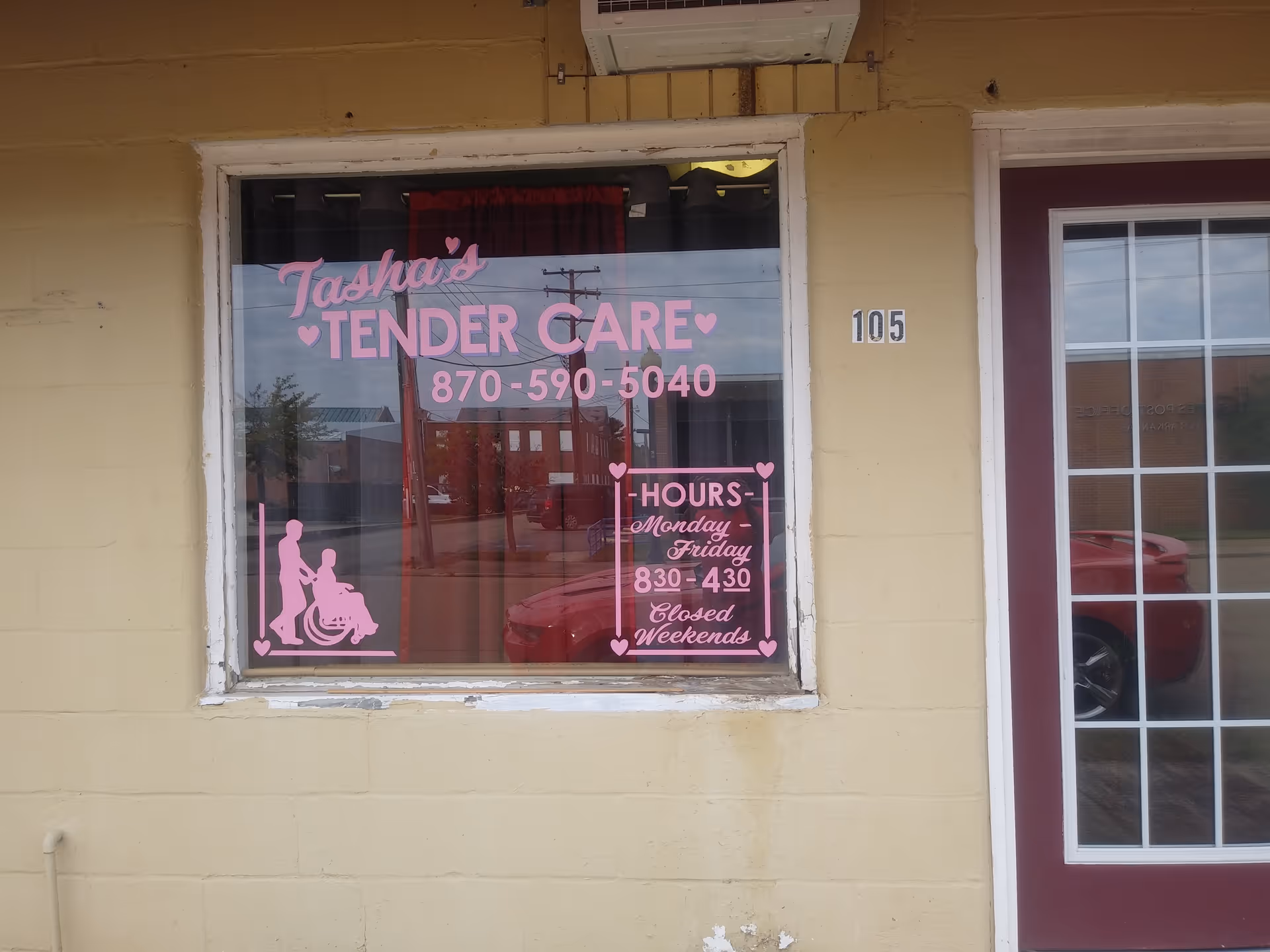 Exterior view of Tasha's Tender Care storefront with pink signage and wheelchair graphic.