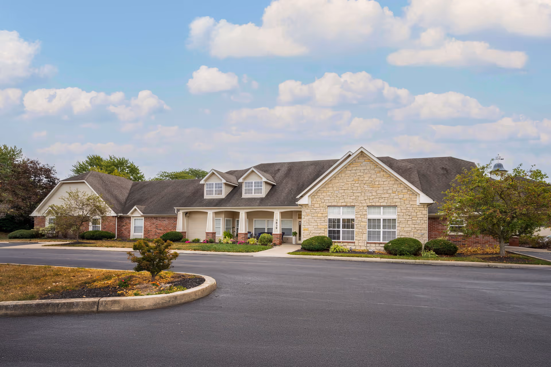 Exterior view of Brookdale Beavercreek building with driveway and landscaped entrance.