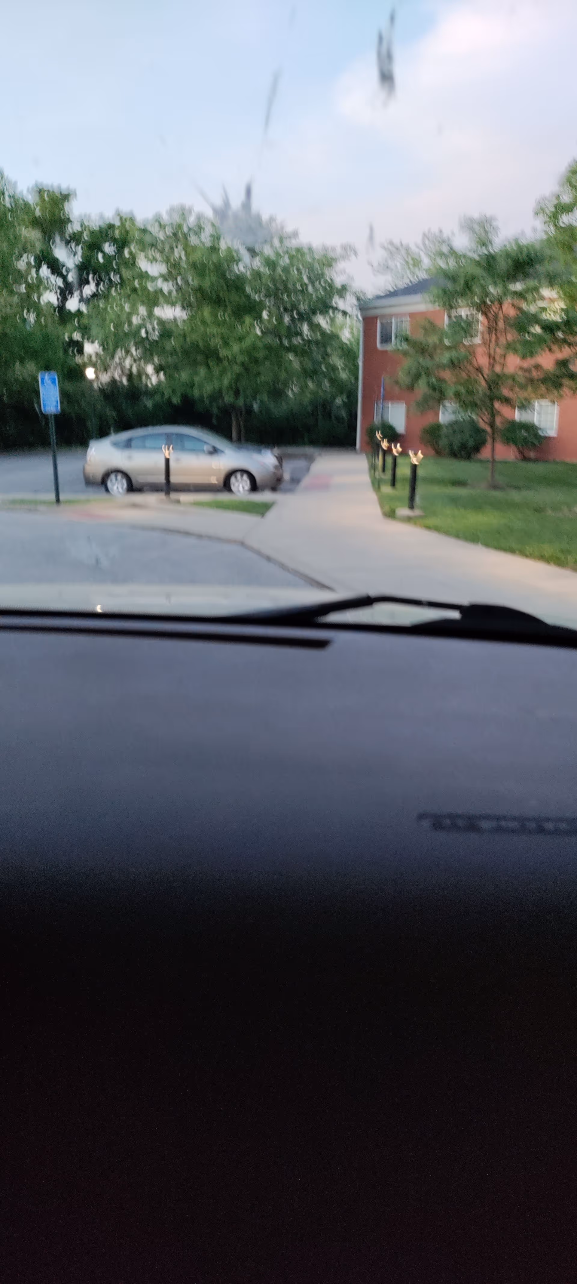 View from inside a car of building exterior and parking lot at Colonial Heights Senior Living.
