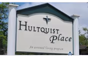 A large exterior sign reads Hultquist Place, with 'An assisted living program' beneath.