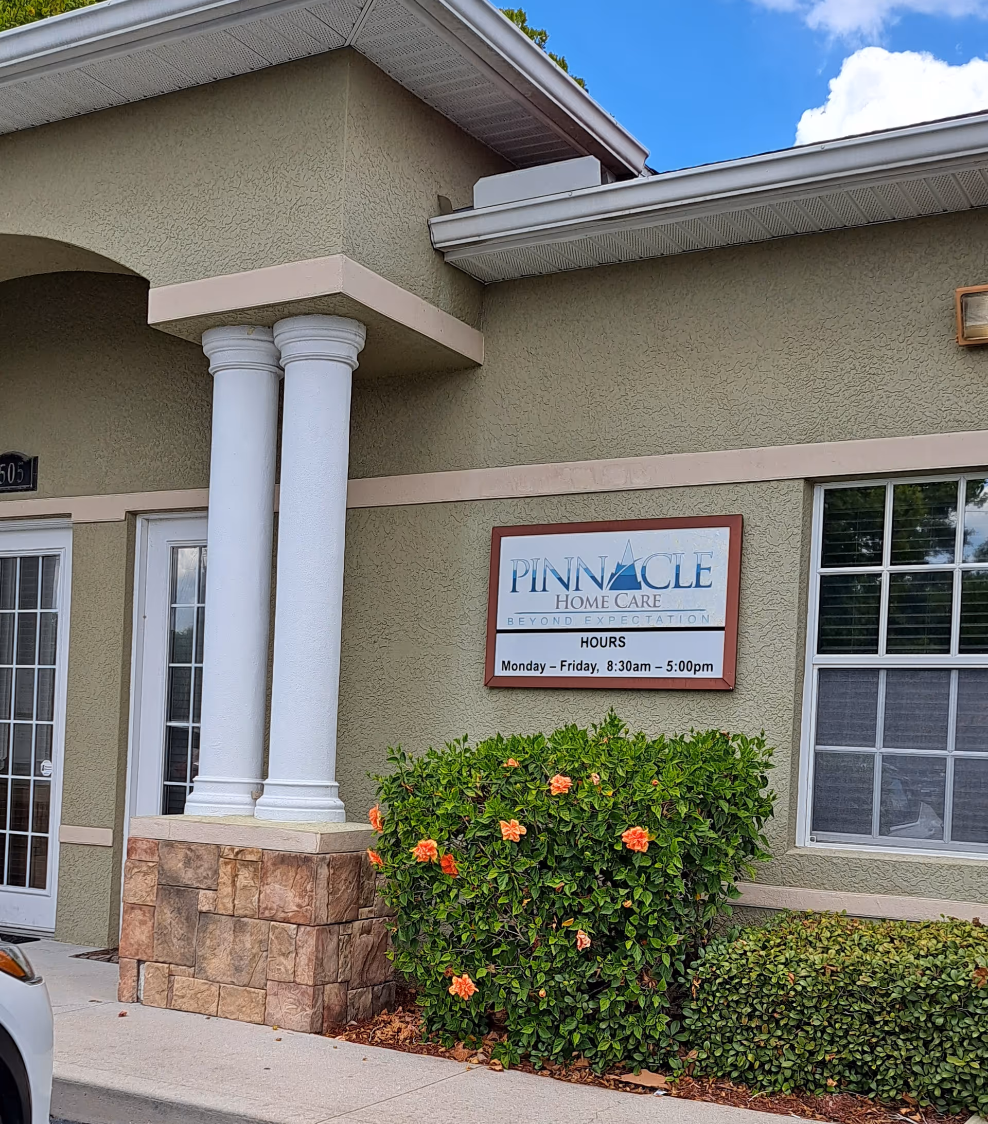 Front exterior view of Pinnacle Home Care building with sign and landscaping.