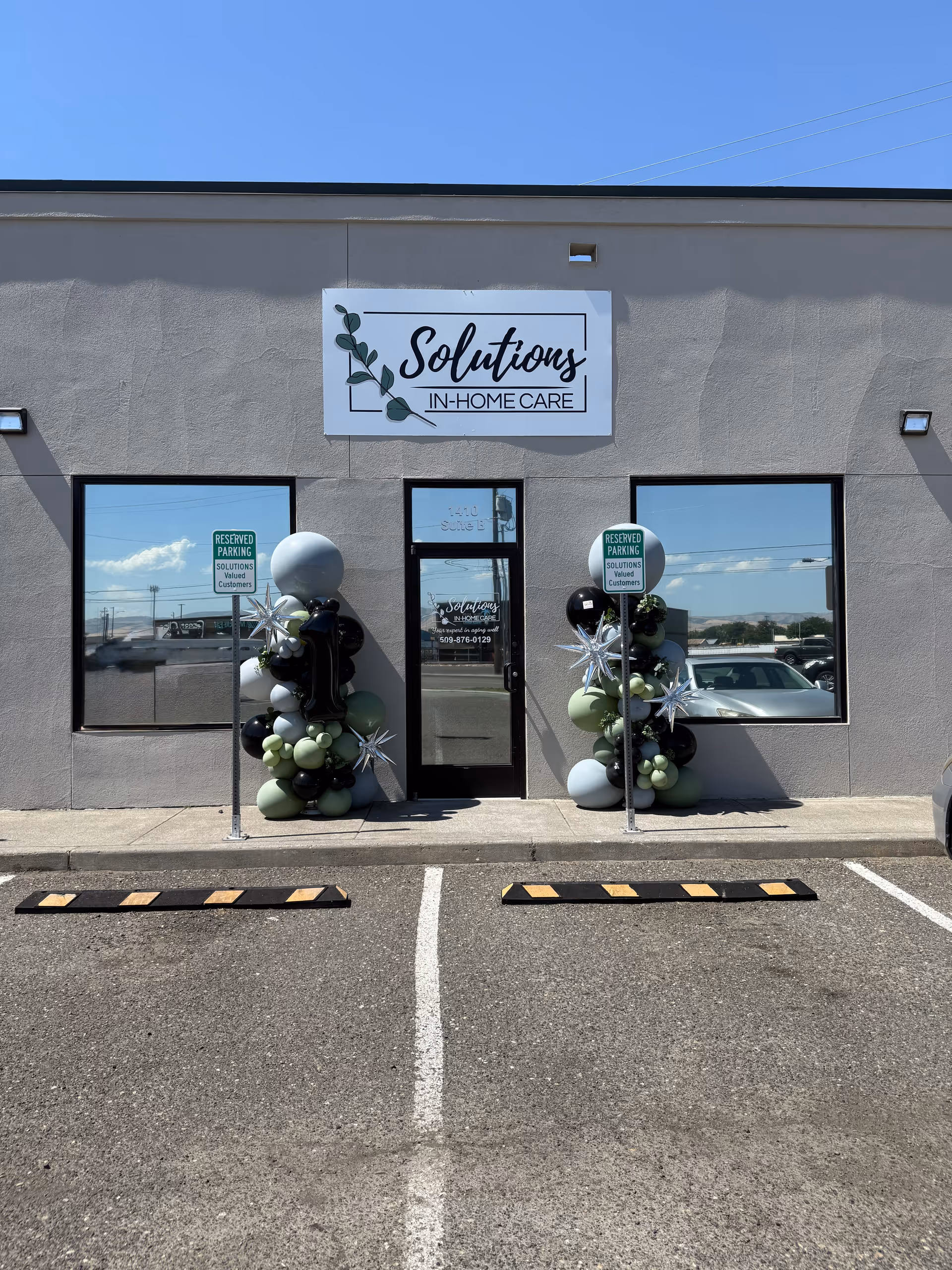 Front exterior of Solutions In-Home Care building with balloon decorations at entrance