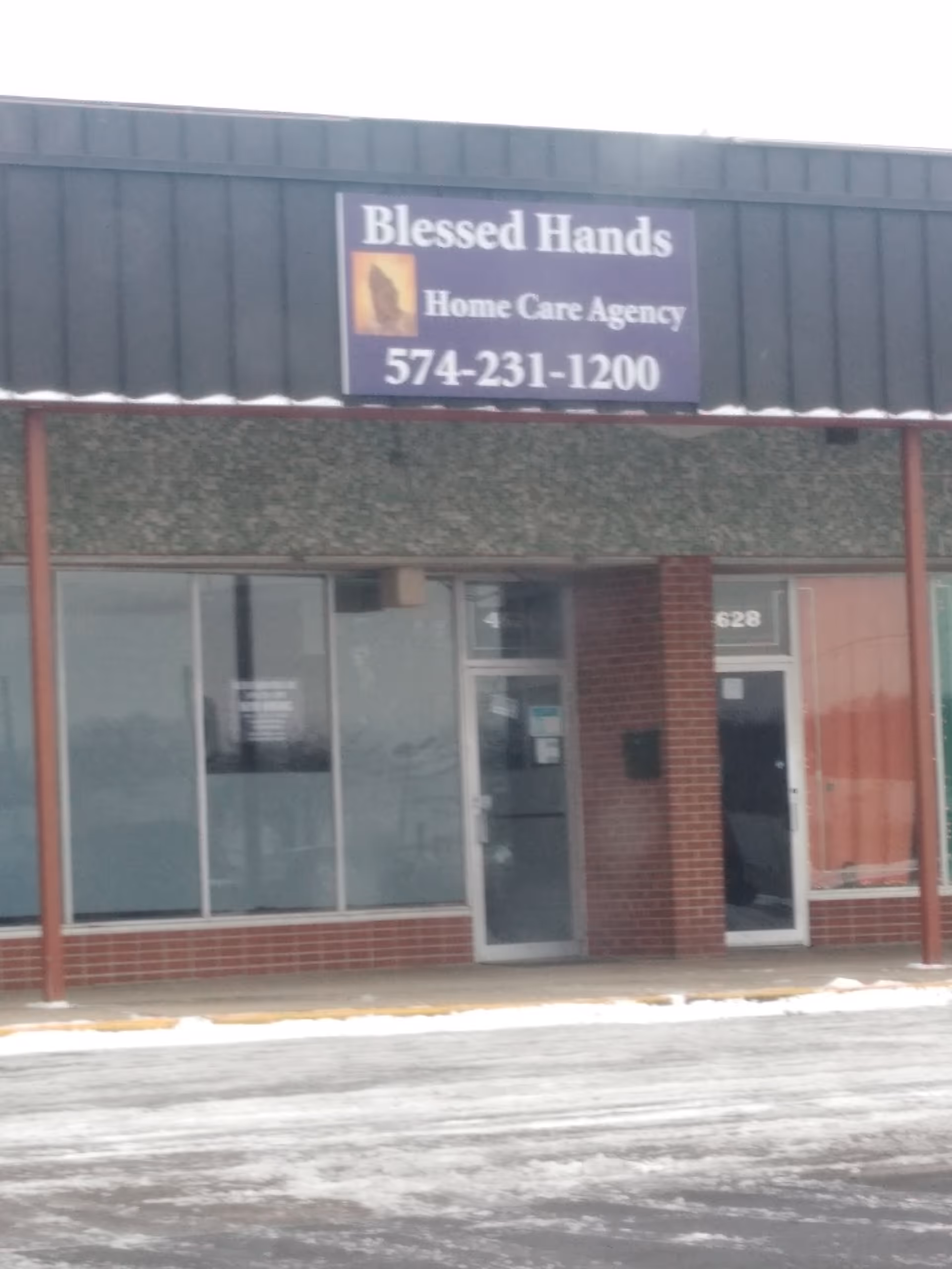 Front view of Blessed Hands Home Care Agency storefront with large sign.