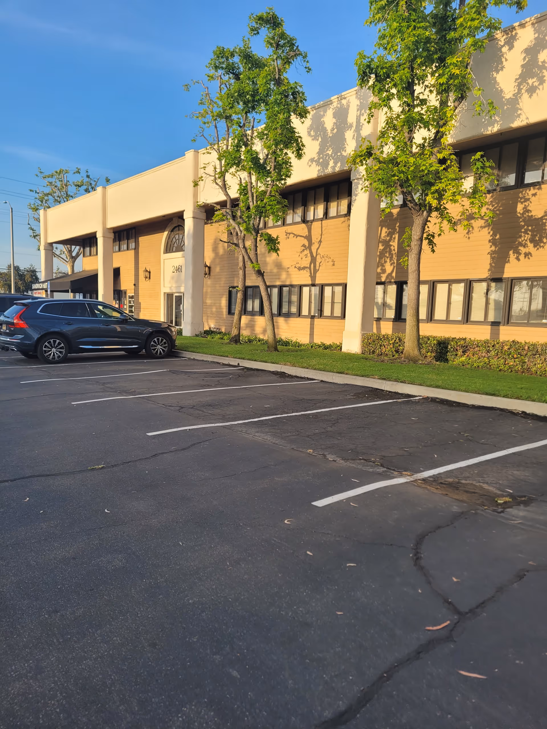 Exterior view of ameriCARE Central Orange County building with parking lot and trees