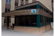 Exterior view of Northern Riverview Health Care Center entrance with teal awning