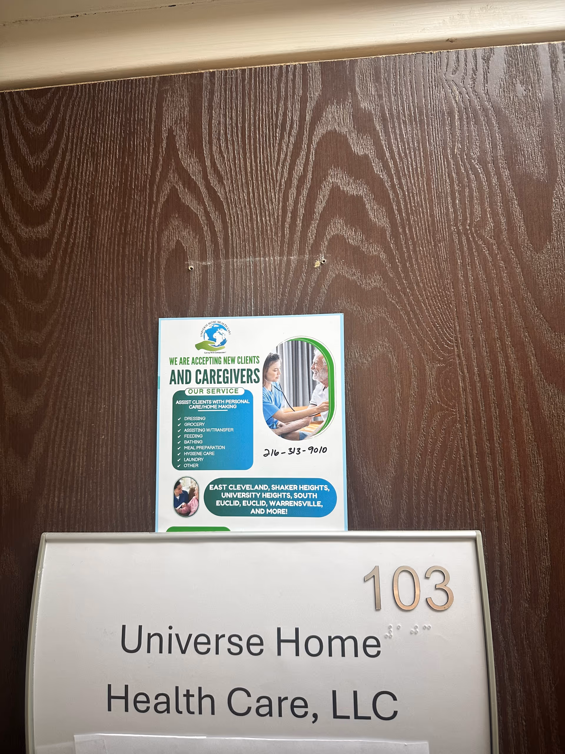 Door plaque reads Universe Home Health Care, LLC with 103 on a wooden wall