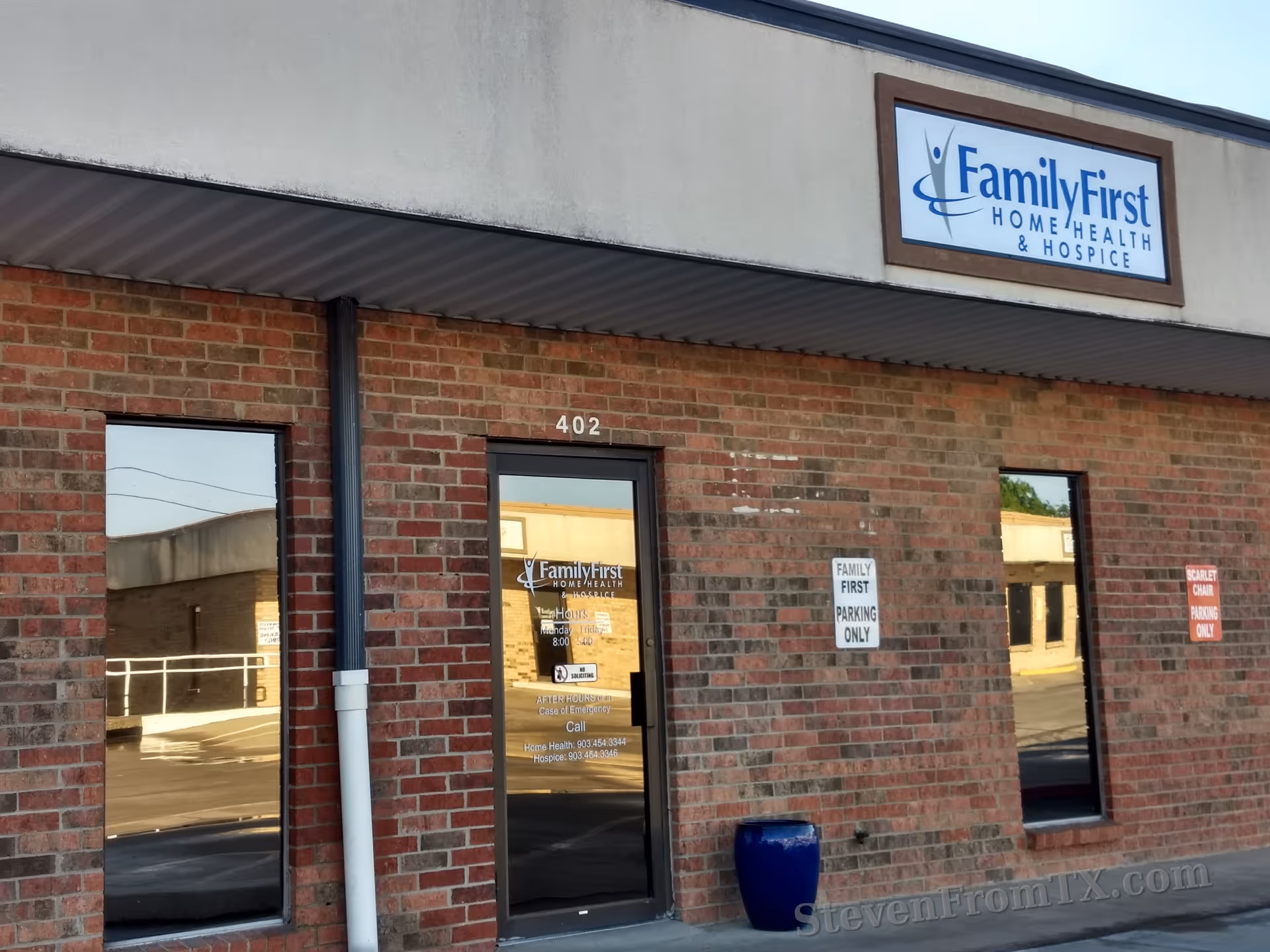 Brick facility facade with Family First sign and entrance door labeled 402.