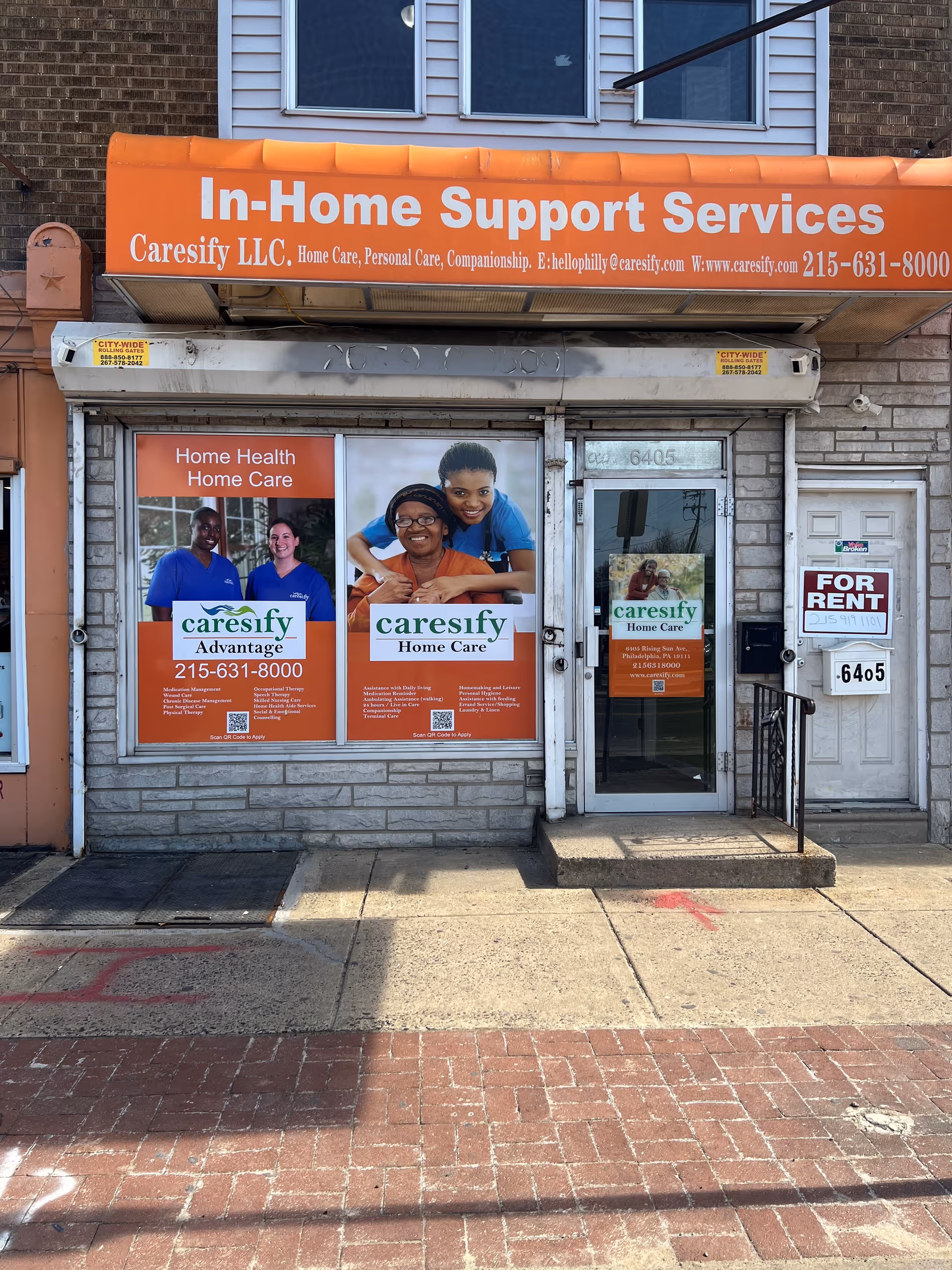Orange storefront sign for In-Home Support Services atop a brick building exterior.