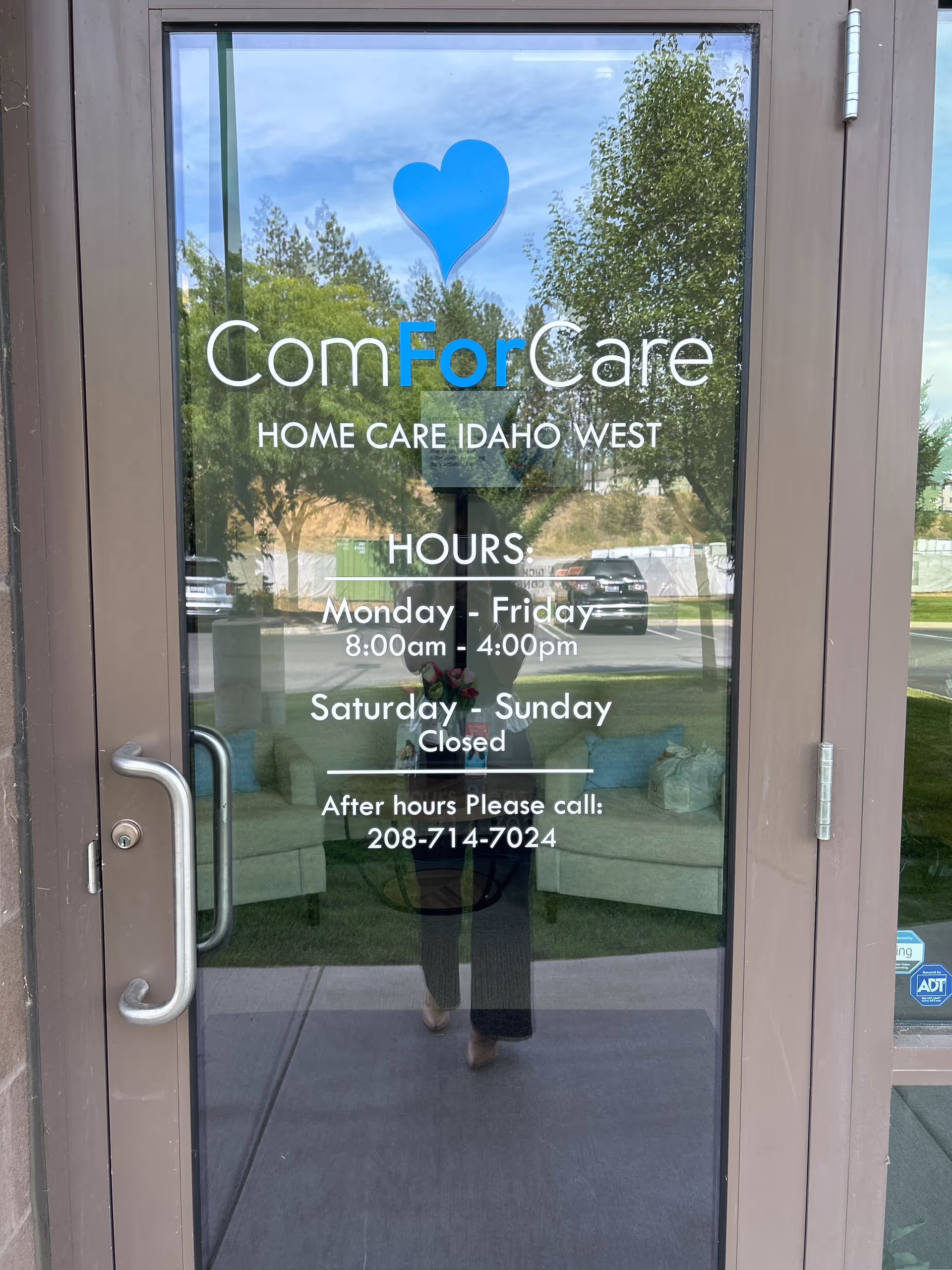 Glass entrance door displays ComForCare Home Care Idaho West sign and hours.