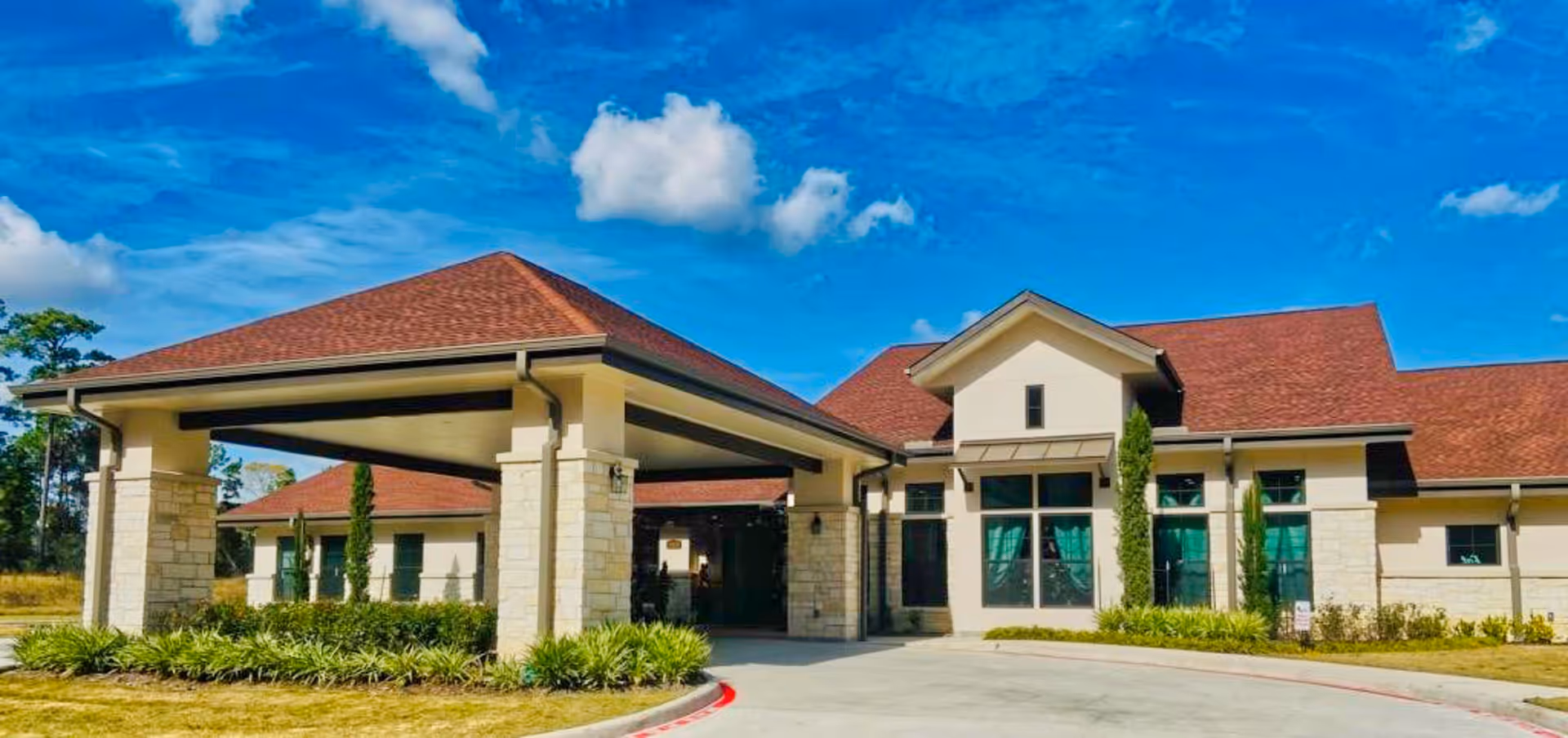 Front exterior of The Bradford Memory Care and Assisted Living, a single-story building with a porte-cochere.