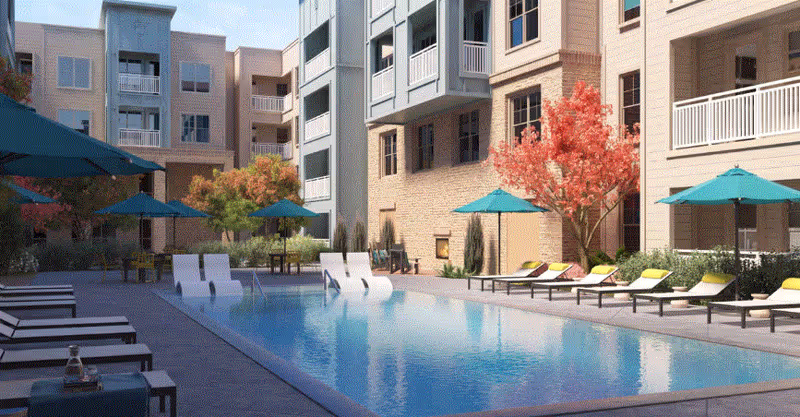 A pool area surrounded by lounge chairs and trees in a senior living facility.